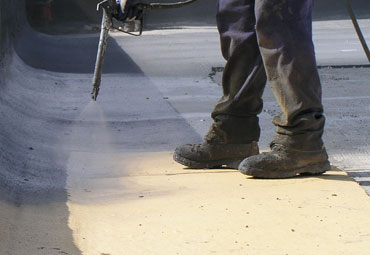 Coating systems over Jackson spray foam roof systems